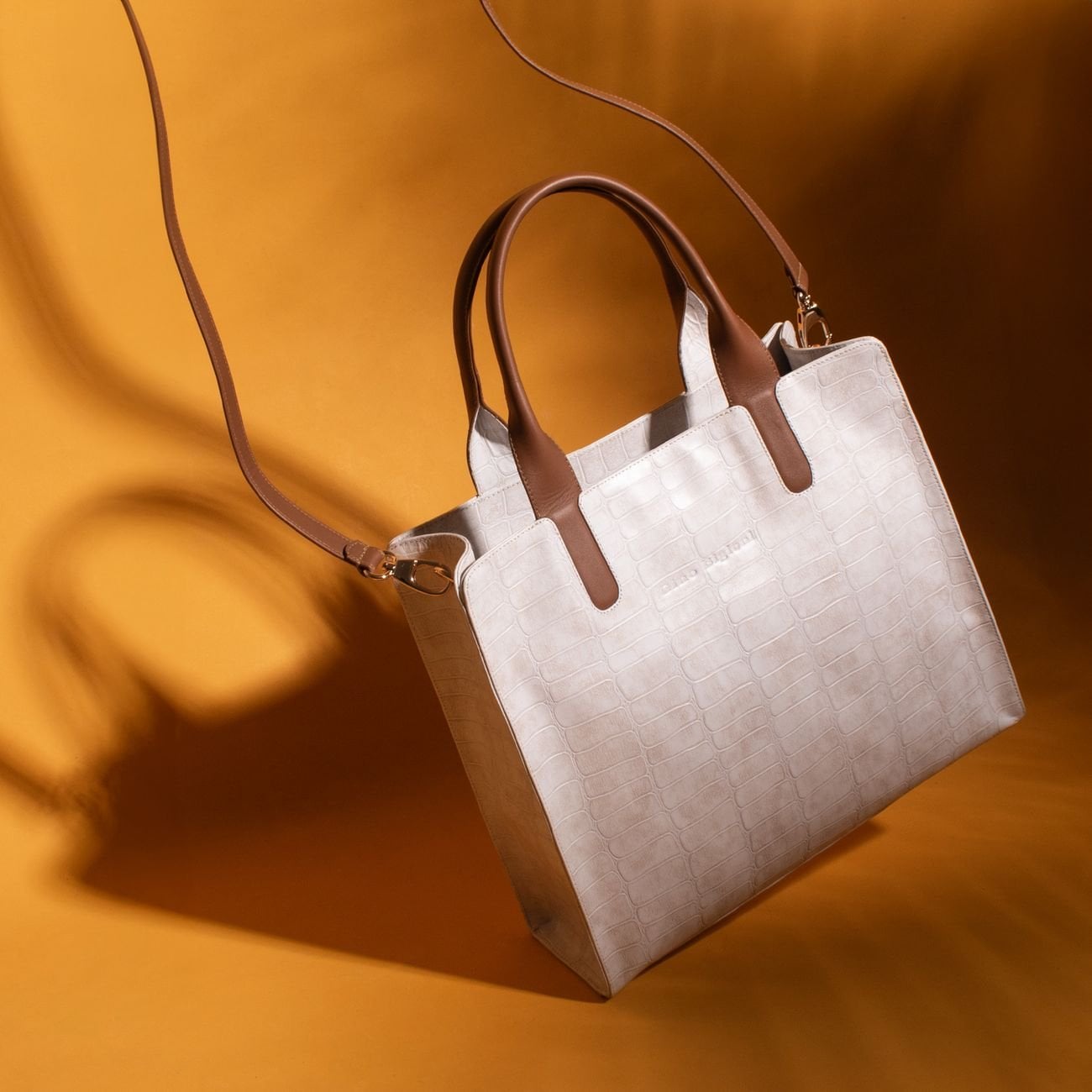 Elegant crocodile pattern handbag in warm studio tones