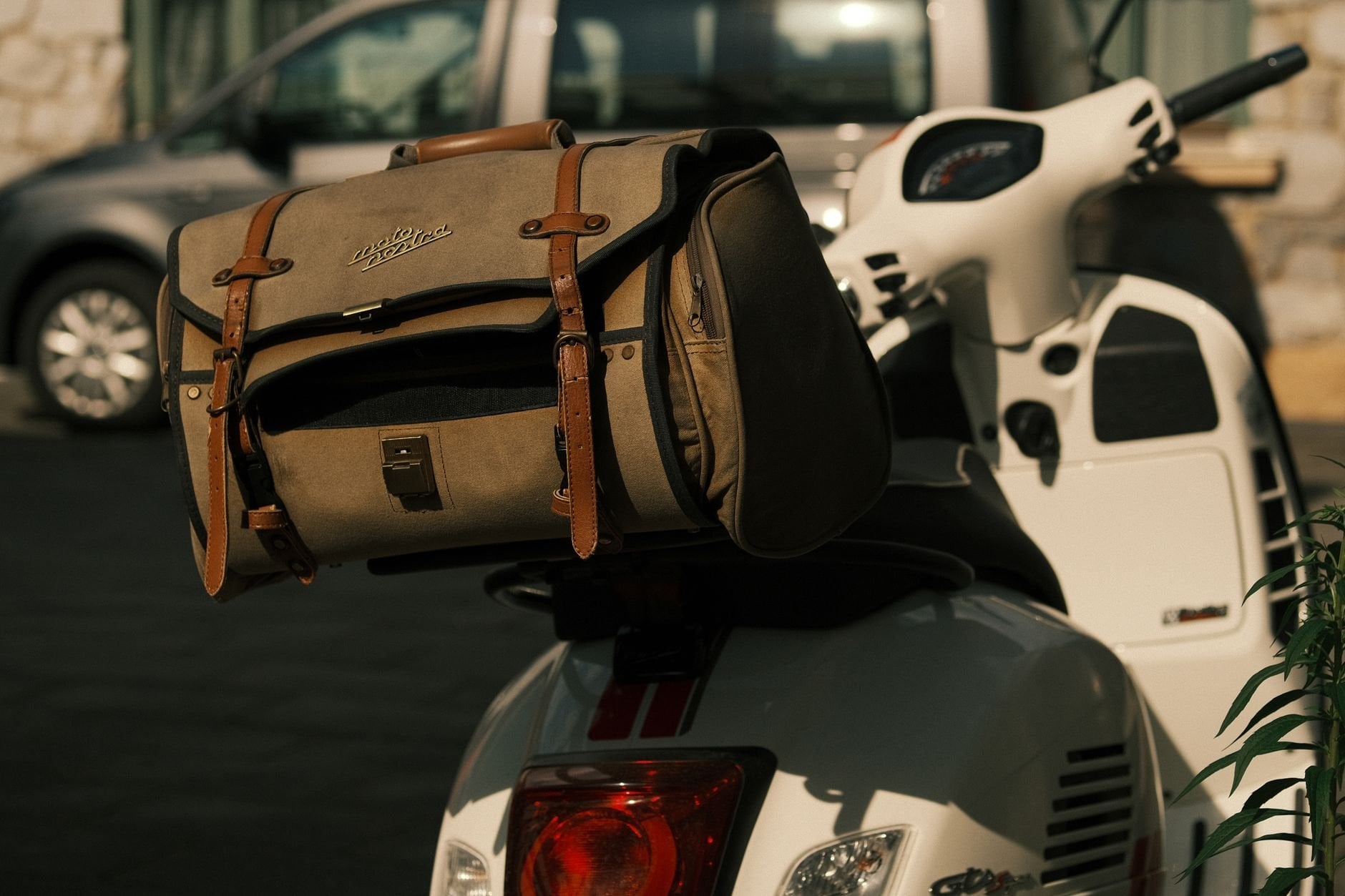Stylish leather bag in warm sunlight — travel accessory in retro-elegant style