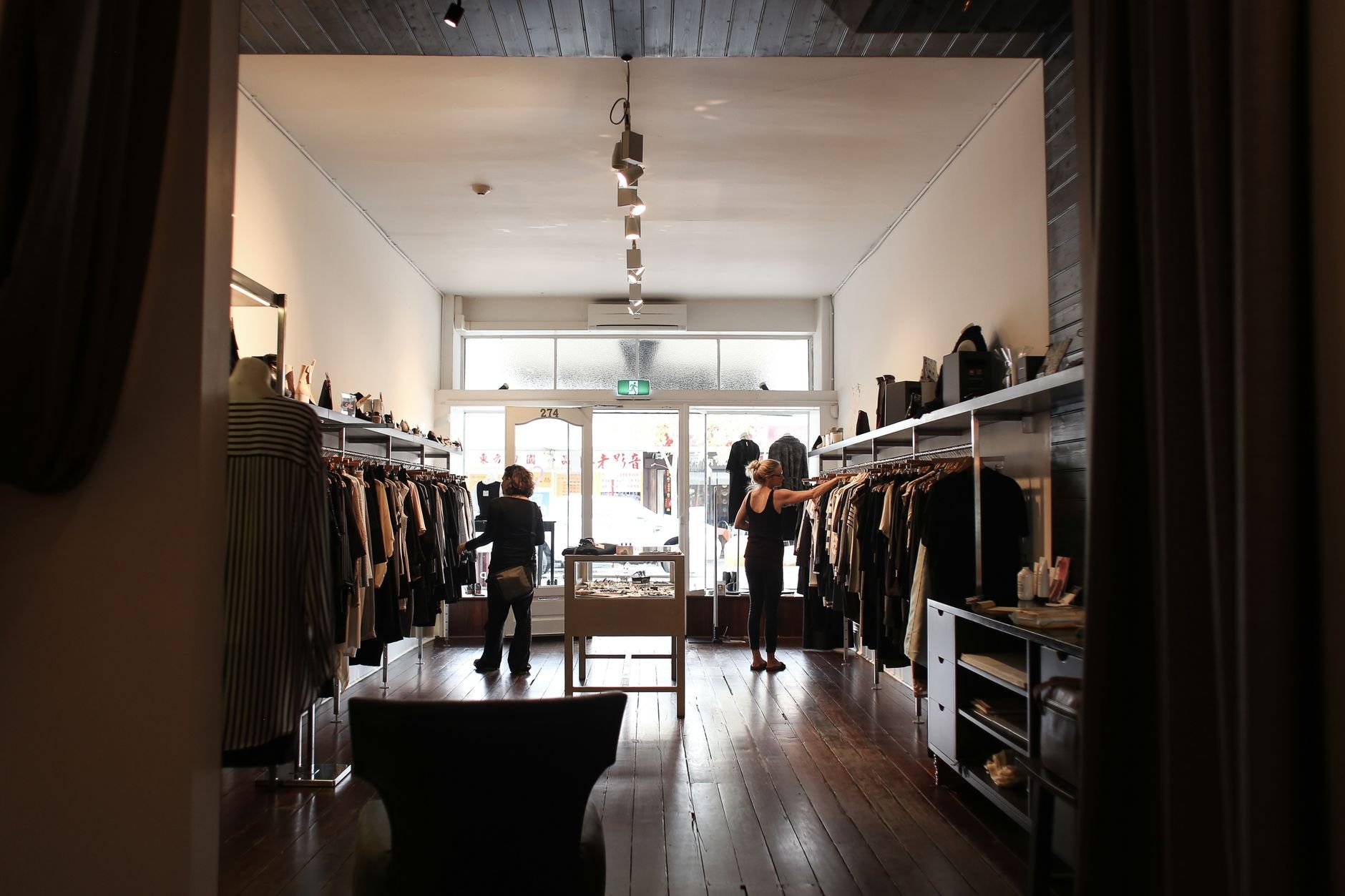 Customers browsing clothing in an elegant boutique interior